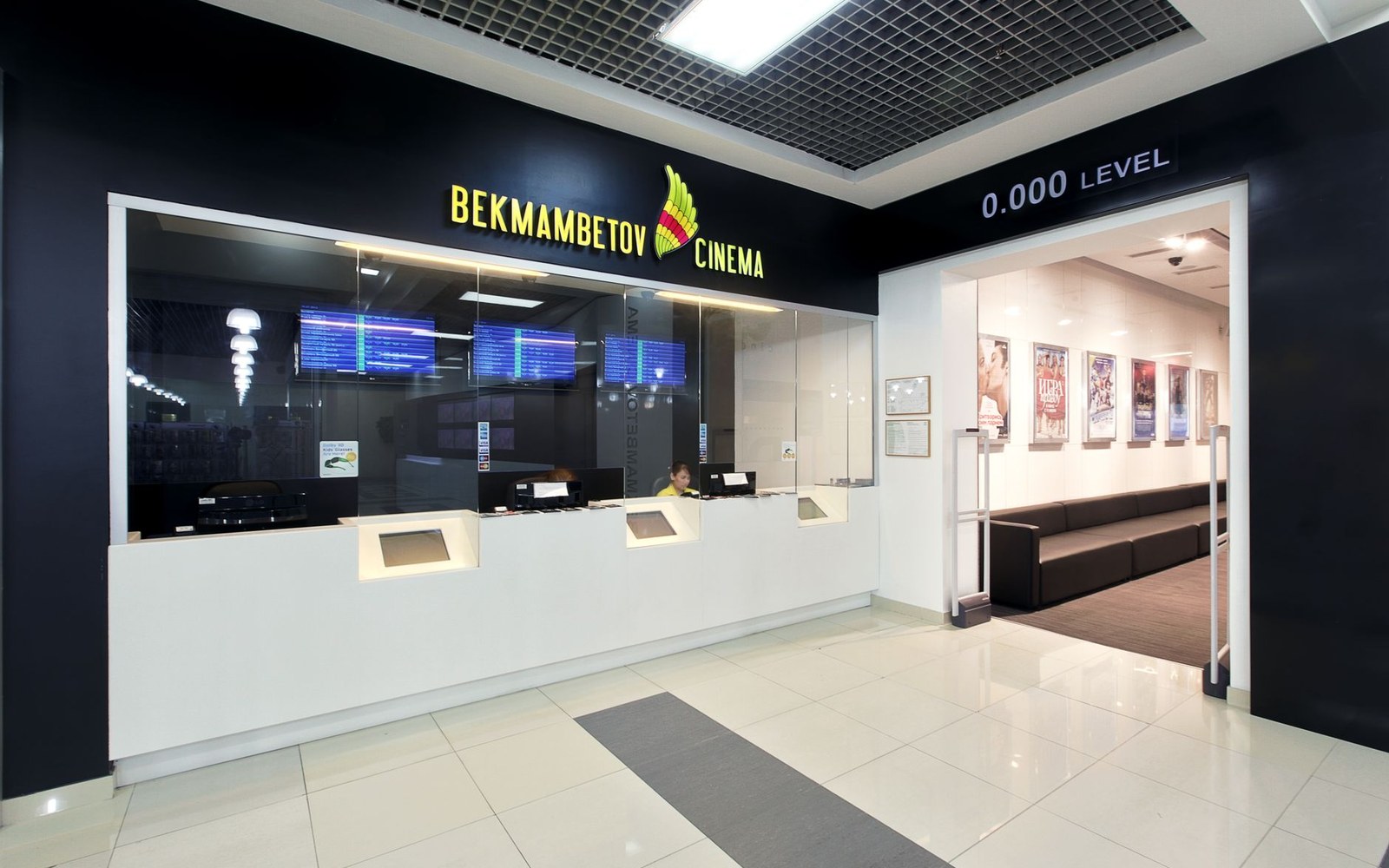 Ticket counter and lobby entrance at Bekmambetov Cinema with movie posters visible